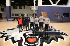 Education and Basketball Enrichment Program winners pose for a photo on the Wolves practice court.