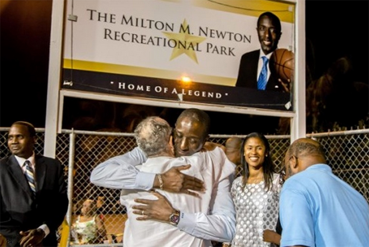 Daily News Photo by AISHA-ZAKIYA BOYD Milt Newton hugs his father, Kent Amos, after the ribbon cutting and unveiling of the sign at Milton M. Newton Recreational Park on Friday night at a ceremony in Bordeaux on St. Thomas.